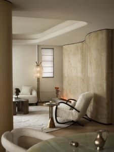 Interior view of a modern living room featuring marble walls and a cozy seating area.