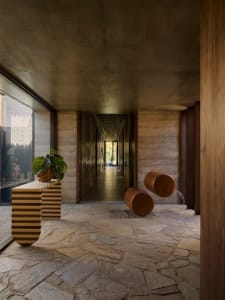 A modern entrance hall featuring a concrete floor and minimalist design.