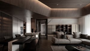 A modern living room featuring wooden furniture and marble accents