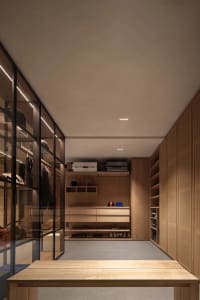 Modern, minimalist wardrobe with light wood finishes and glass cabinets.