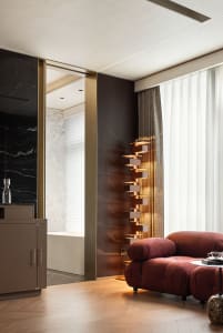 Modern residential interior with marble accents, leather seating, and wooden elements.