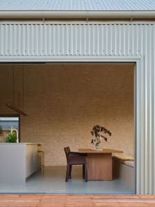 A modern residential kitchen with concrete and wooden surfaces.
