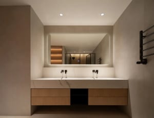 Minimalist modern bathroom with marble countertop and double sinks.