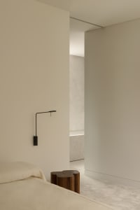 Photograph of a modern bedroom with neutral-toned walls and minimalist decor.