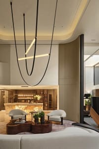 A modern living room with marble flooring, a cozy fireplace, and contemporary furnishings.
