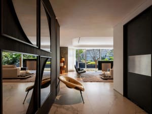 Modern living room with concrete and marble materials, featuring minimalist design.