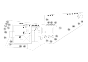 A technical 2D architectural floor plan with various rooms and outdoor areas.