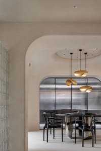 Modern interior design featuring contemporary metal lighting fixtures with curved designs.