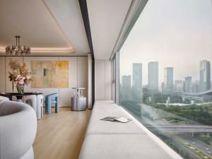 Modern living room with large windows overlooking a cityscape.