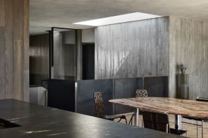 Industrial restaurant interior with concrete walls and marble table