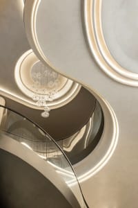 A sleek, modern staircase with glass circular elements and minimalistic design features.