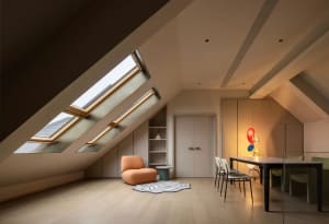 A modern contemporary living room featuring a wooden floor, glass windows with skylights, fabric seating, and minimalist deco