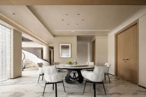 Modern dining room with marble table, white leather chairs, and black base