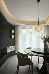 Modern dining room featuring marble and glass elements.