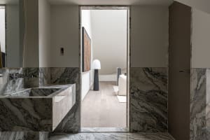 Modern bathroom with marble floors and suite, showcasing contemporary design elements