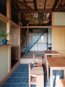 Modern residential interior with wooden furniture and a bookshelf.