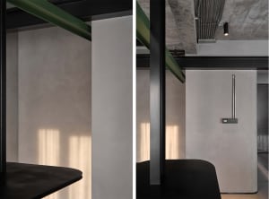 Clean, minimalist office interior with concrete walls and modern furniture.
