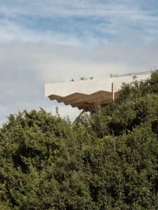 A modern architectural exterior featuring concrete and metal structures.