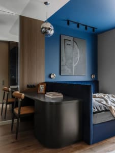 A modern bedroom with a blend of wood, fabric, and metal materials.