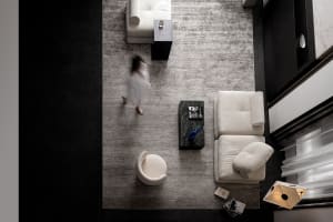 An overhead view of a modern interior design with white sofas and fabric upholstery.