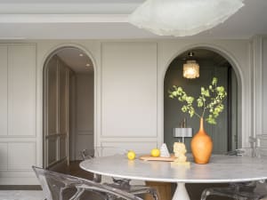 Minimalist dining room featuring marble table and transparent chairs