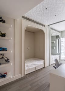 A modern minimalist bedroom with a built-in bunk bed and a desk area.