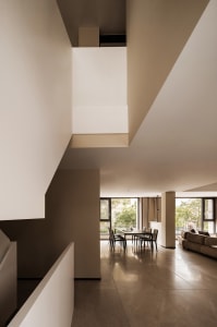 Modern dining room with sandstone surfaces and minimalist design.