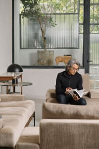 A modern interior space featuring contemporary sofas, glass tables, and leather chairs.