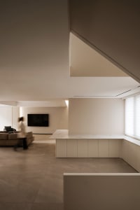 A modern minimalist living space with clean lines and neutral tones.