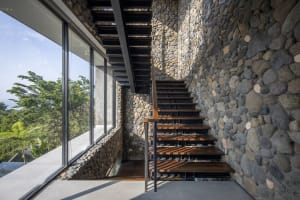 Modern residential architecture featuring stone and wooden elements.