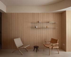 Modern interior space featuring wooden paneling, minimalist furniture, and a sleek, contemporary design.