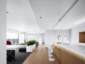 A modern residential kitchen with white marble countertops and minimalist design elements.