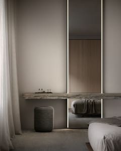 Modern bedroom featuring sleek, minimalist design with concrete elements.