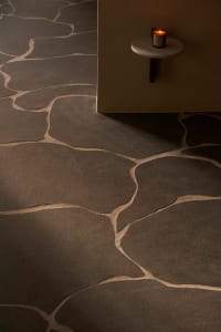 A modern interior space featuring stone floor tiles with a natural, irregular pattern.