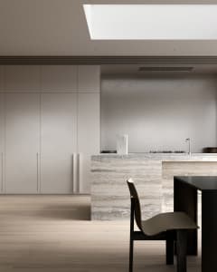 A modern minimalist kitchen featuring marble countertops and sleek design elements.