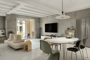 A modern living room with a white concrete and stone floor, industrial-style furniture, and a minimalist design aesthetic.