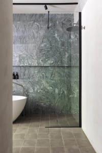 Modern bathroom featuring marble walls and floor