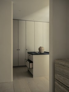 A modern minimalist kitchen with a laminated wood countertop and cupboard.