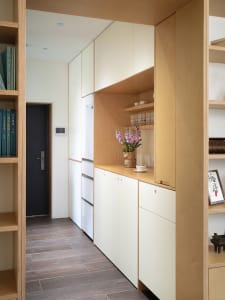 Modern kitchen featuring minimalist storage solutions and wooden paneling.