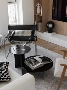 A modern minimalist living room featuring wooden tables and minimalist furniture.