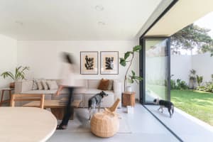 A modern living room with a neutral color palette showcasing plush seating, stylish decor, and a seamless transition to an ou