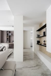 A minimalist interior design featuring concrete and marble materials.