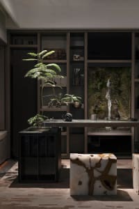 Modern living room with marble accents and a glass partition