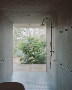 Modern bathroom with concrete walls and minimalist design.