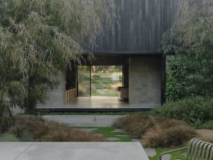 Modern residential exterior with wooden elements and landscaping