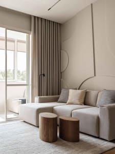 Modern minimalist living room with neutral tones and a large window