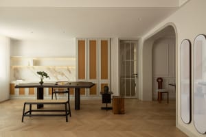 Modern residential kitchen featuring marble countertops and cane furniture.