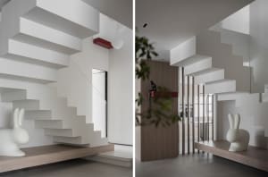 Concrete floating staircase with white rabbit sculpture