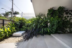 A modern interior living space featuring concrete walls and floor.