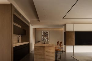 A minimalist, modern kitchen with marble countertops and flooring.